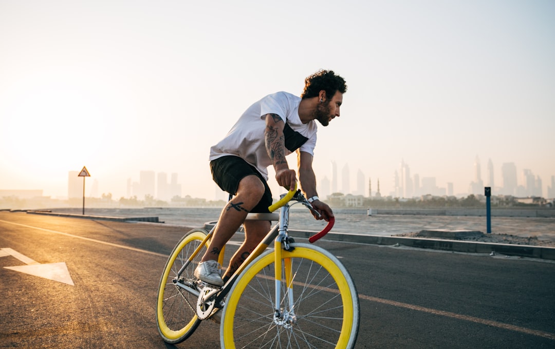 Photo by Jonny Kennaugh man riding bicycle on road during daytime